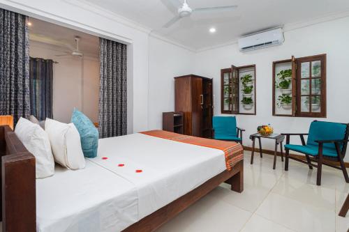 a bedroom with a bed and a dining room at Lohas Beach Villa in Kalutara
