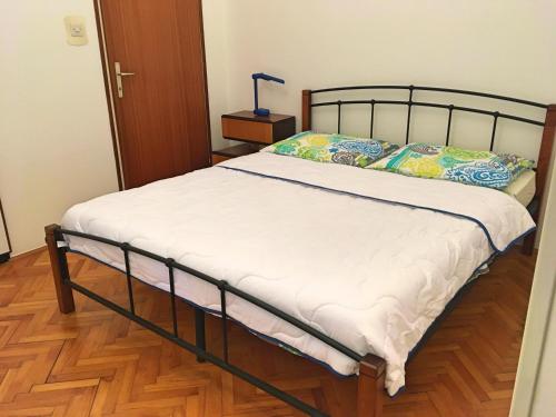 a bed in a room with a wooden floor at ORTHOPEDIC CENTER NEAR WITH FREE PARKING, Quite and Privately in Lovran