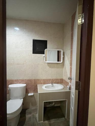 a bathroom with a toilet and a sink at ใบไม้ in Ko Si Chang