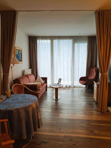 a living room with a couch and a table at Hotel Garni Günther in Postal