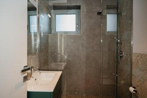 a bathroom with a shower and a sink and a shower at LVguesthouse in Priocca