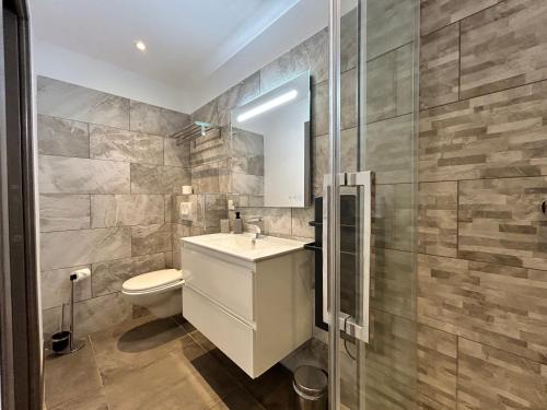 a bathroom with a toilet and a sink and a shower at Residence Capriona in Porto Pollo