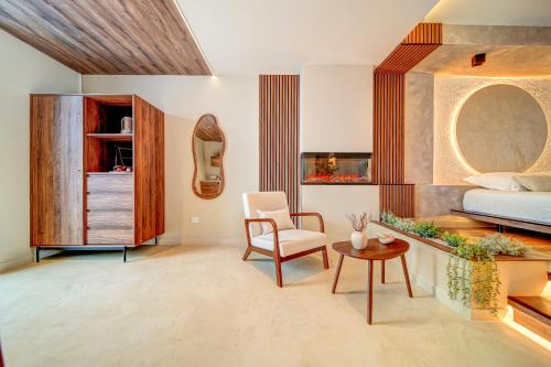a bedroom with a bed and a chair and a table at Suite Moon & Spa in Amnéville