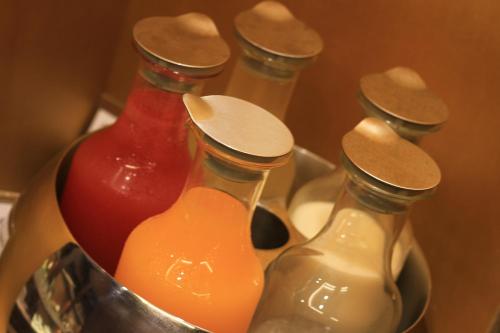 a group of three glass bottles with wooden tops at The Scarlett Boutique Hotel in Hue