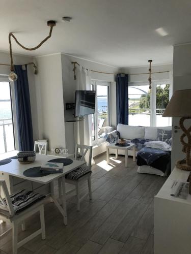 a living room with a couch and a table at Strandhaus-Seeschwalbe in Fehmarnsund