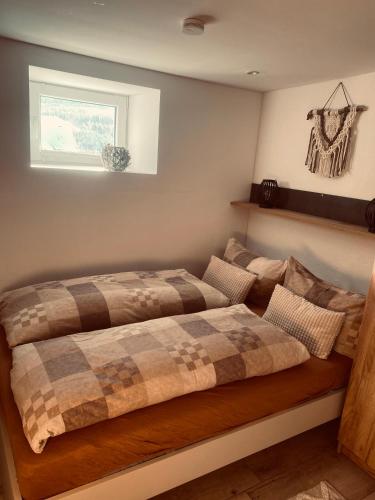 a bedroom with a bed with a blanket on it at Ferienwohnung Leadro in Kurort Oberwiesenthal