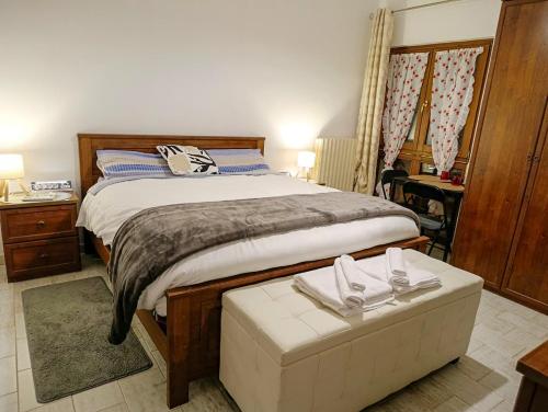 a bedroom with a large bed with a foot board at La Corte Nelle Vigne in Lavagno