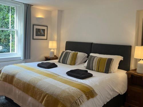 a bedroom with a bed with two towels on it at Luccombe Villa Holiday Apartments in Shanklin
