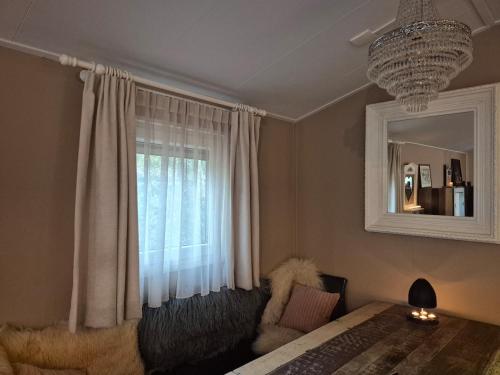 a bedroom with a bed and a window at Parel van het bos in Norg