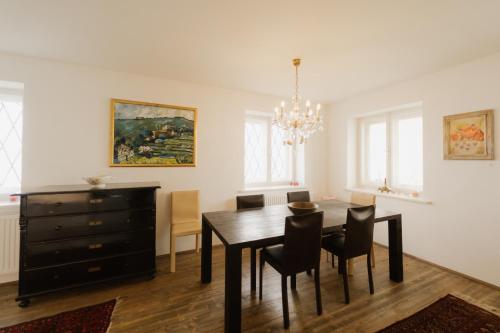 a dining room with a table and chairs and a dresser at Exklusives Ferienhaus in Alleinlage mit privater Sauna - La petite maison in Straden