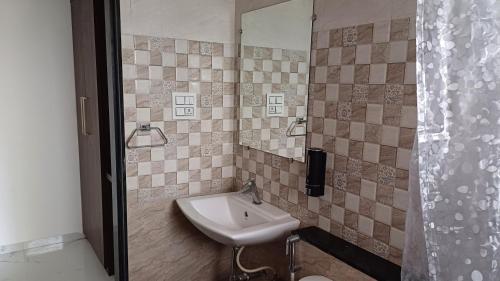 a bathroom with a sink and a mirror at Machan Villas by Holiday Club in Bhor