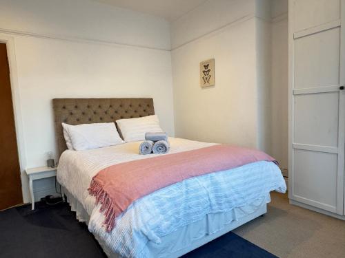 a bedroom with a bed with a stuffed animal on it at Street Lane Roundhay in Moortown