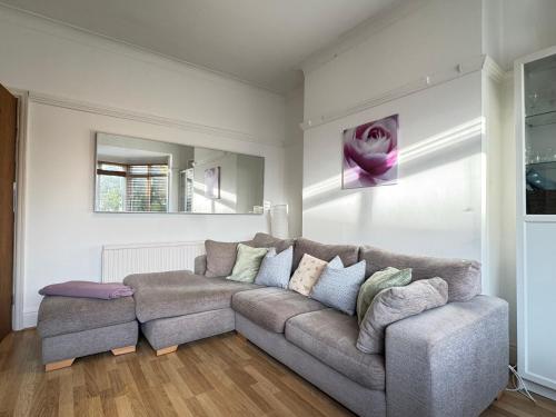a living room with a couch and a mirror at Street Lane Roundhay in Moortown