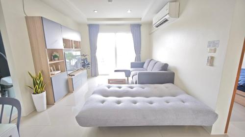 a living room with a couch and a chair at The Two bedrooms Two bathrooms in Phuket Old Town in Phuket