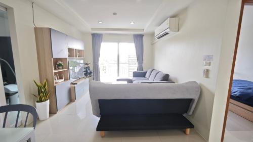 a living room with a couch and a bed at The Two bedrooms Two bathrooms in Phuket Old Town in Phuket