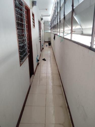 an empty hallway of a school with a long aisle at 14 Hostel DMK airport in Bang Khen