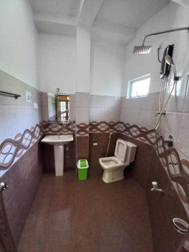 a bathroom with a toilet and a sink at Sethun House in Mirissa