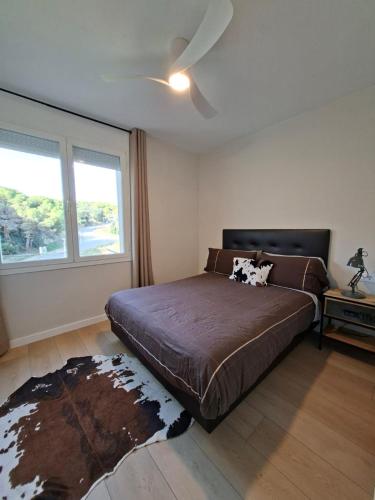 a bedroom with a large bed and a window at Apartment Beach Front Sant Pol in San Pol de Mar