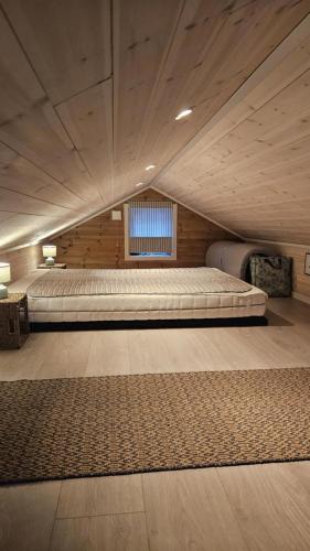 a large room with two beds and a window at Hyttekos i Telemark in Åmli