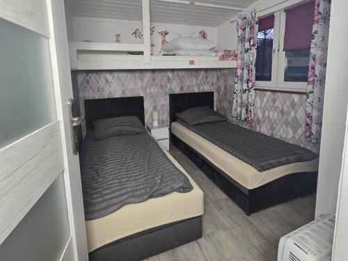 two beds in a small room with two beds sidx sidx sidx at Agroturystyka Nad Stawem in Sulęcin