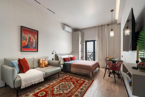 a living room with a couch and a bed at Blueloft 65 I Apartment with Balcony and City View in Tashkent
