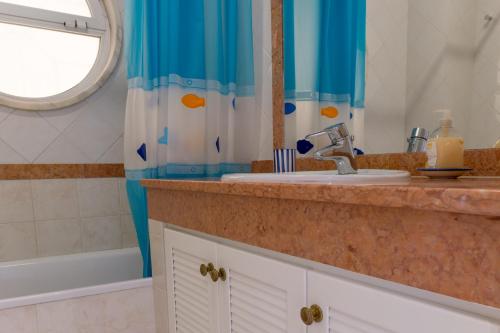 ヴィラモウラにあるAkisol Vilamoura Soft IIIのバスルーム(シンク、鏡、バスタブ付)