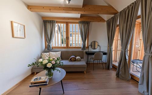 a living room with a couch and a table at Old Coach House in Bled
