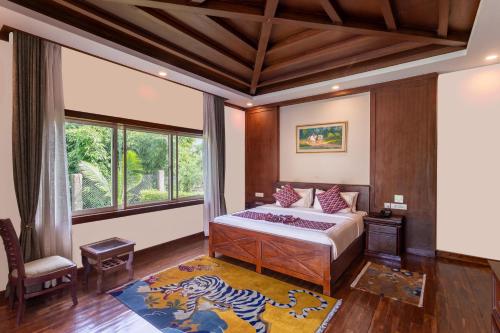 a bedroom with a bed and a zebra rug at River Bank Jungle Resort, Chitwan in Chitwan
