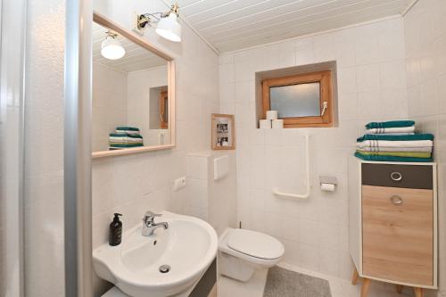 a white bathroom with a sink and a toilet at Ferienhof Kopf in Mäder
