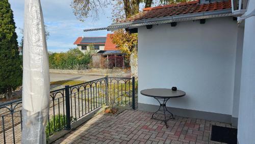 a small patio with a table and a fence at Ferienhaus Meli in Pürgen