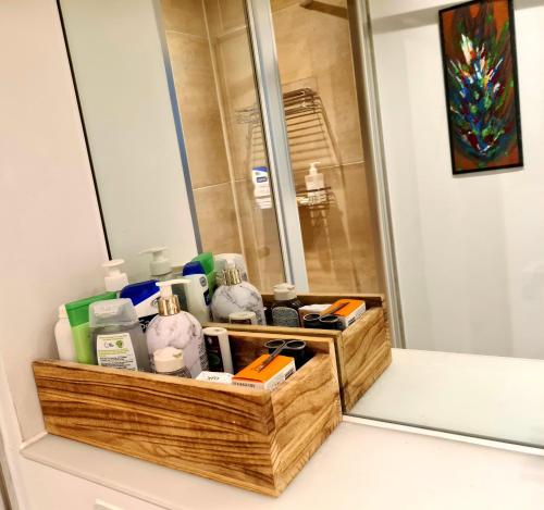 a bathroom with a vanity with a mirror and a basket at Superb Guest Room in London