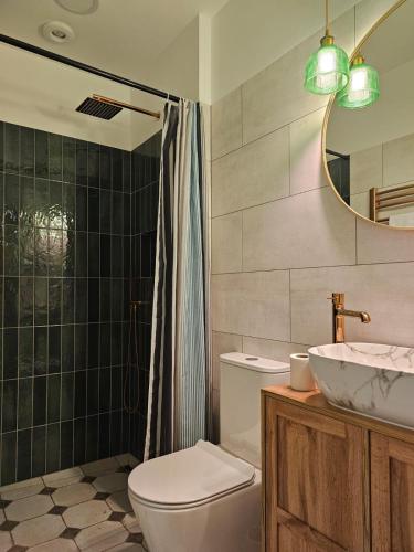 a bathroom with a toilet and a sink and a mirror at POD ORŁEM in Wałcz