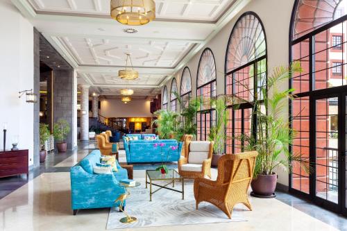 a lobby with blue furniture and large windows at Gran Tacande Wellness & Relax Costa Adeje in Adeje