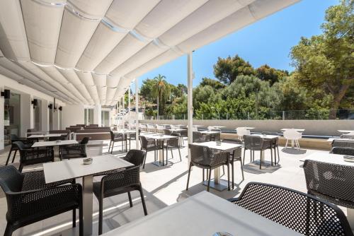 an outdoor patio with tables and chairs on a patio at Tacande Portals in Portals Nous