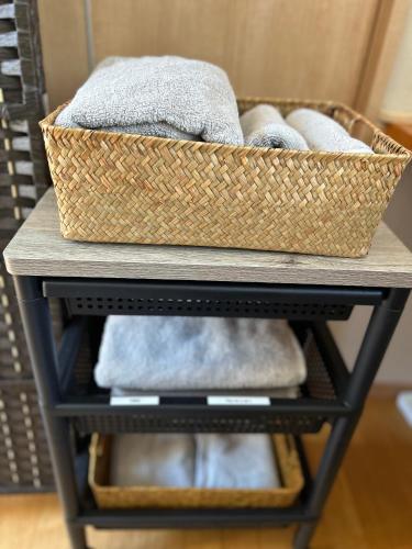 a basket on top of a table with towels at ゲストハウスHayatamaわびさび in Shingū