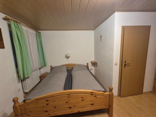 a bedroom with a wooden bed in a room at Zum Bergbauern in Waidhaus