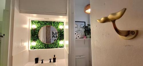 a bathroom with a sink with a mirror and a mirror at tiki tides in Umdloti