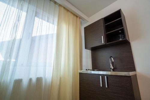 a bathroom with a sink and a window at Hotel Golf Luxury in Kruševac