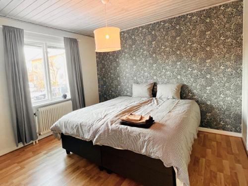 a bedroom with a large bed with a wall at Homey Stay in Halmstad