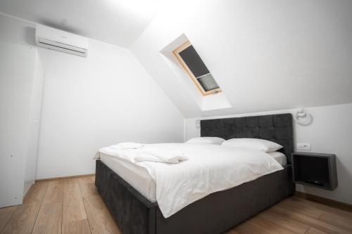a bedroom with a large bed and a television at Pensiunea 82 in Nădlac