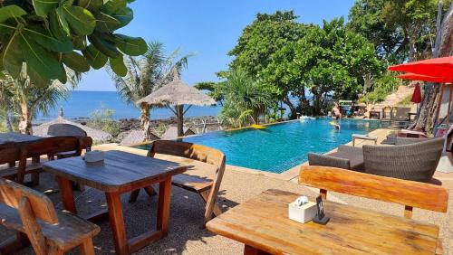 a pool with a table and chairs and a table and a table at Coco Tent Seaview 360 in Ko Lanta