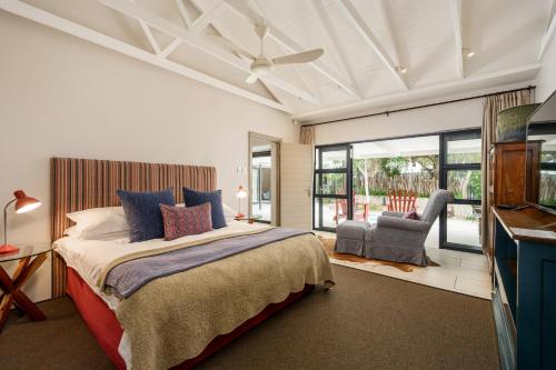 a bedroom with a king sized bed and a window at Ocean Breeze by The Oyster Collection in Kenton on Sea