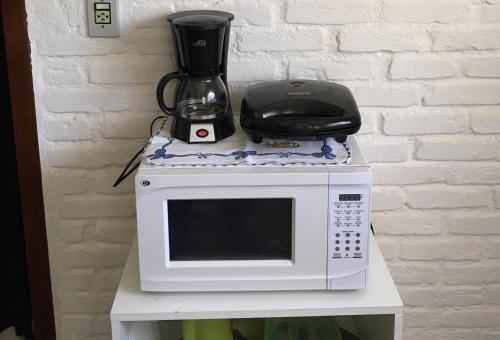 a microwave on a table with a blender on it at Passarim Chalé in Monte Verde