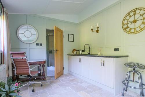 a kitchen with a sink and a desk and a clock at 5 Bed in Devizes oc-s34742 in Devizes