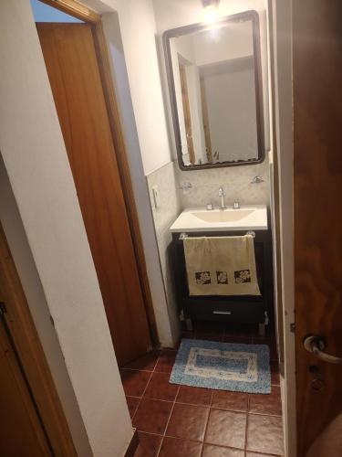 a bathroom with a sink and a mirror at Cabaña Quimey in Villa Rumipal