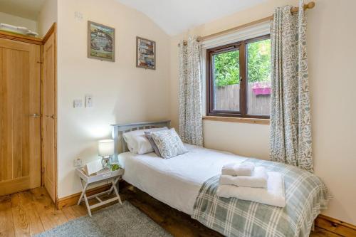 a bedroom with a bed and a window at 2 Bed in Brecon oc-r33603 in Lower Chapel