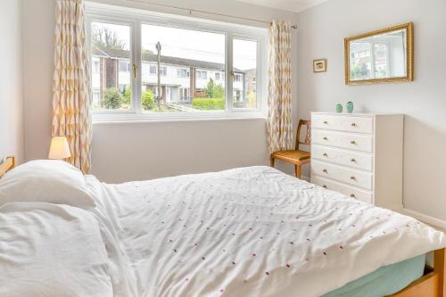 a bedroom with a white bed and a window at 2 Bed in Mumbles oc-d32021 in The Mumbles
