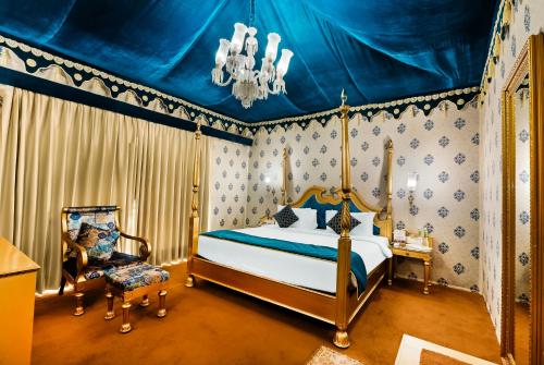 a bedroom with a bed and a blue ceiling at Rajasthali Resort & Spa in Jaipur
