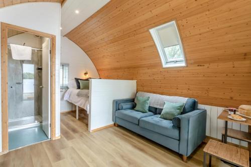 a living room with a blue couch and a bedroom at 1 Bed in Langtoft oc-l32683 in Langtoft