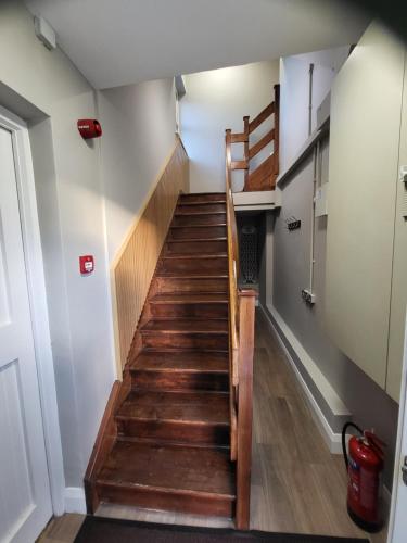 a staircase with wooden steps in a house at Village View in Adare